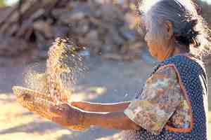 Hopi woman winnows beans in Arizona